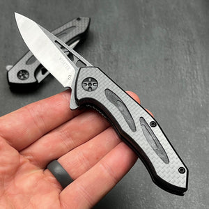 CINDER:  Carbon Fiber Handles,  D2 Drop Point Blade,  Ball Bearing Flipper System