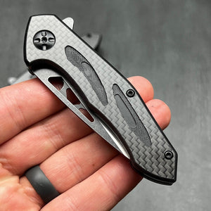 CINDER:  Carbon Fiber Handles,  D2 Drop Point Blade,  Ball Bearing Flipper System