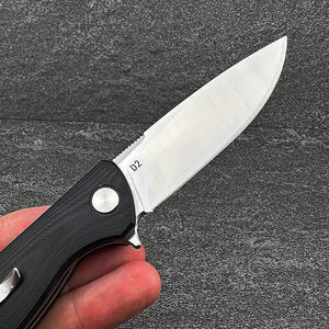 TURRET:  Black G10 Handles, D2 Drop Point Blade,  Ball Bearing Flipper System